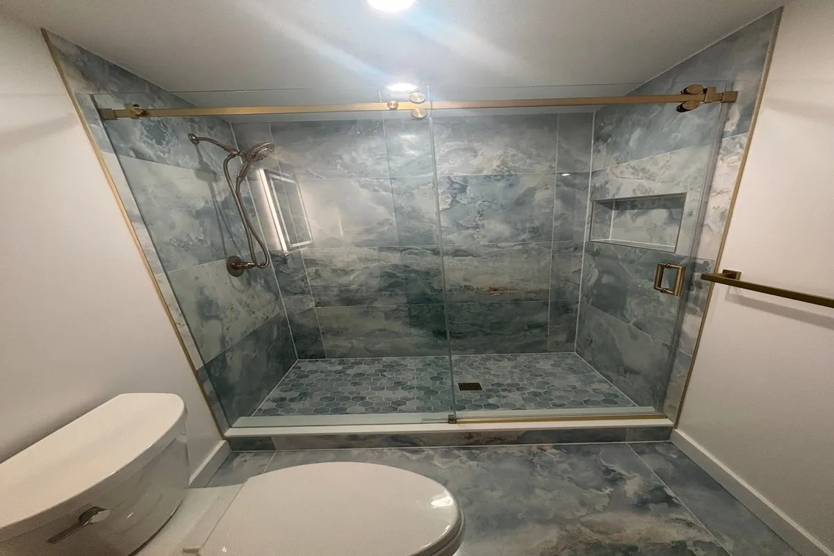 Luxury walk in shower with a hexagon tile floor