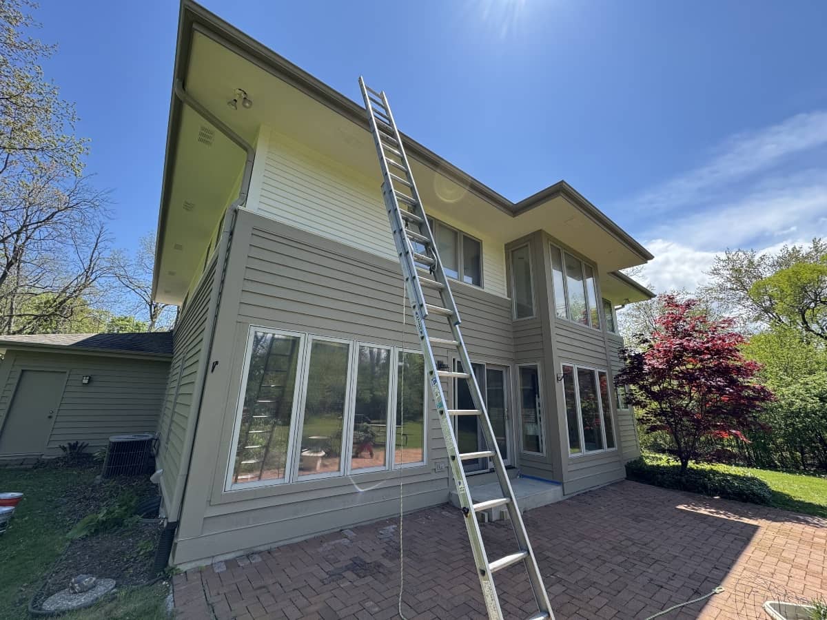 Home exterior with new siding and a ladder during installation