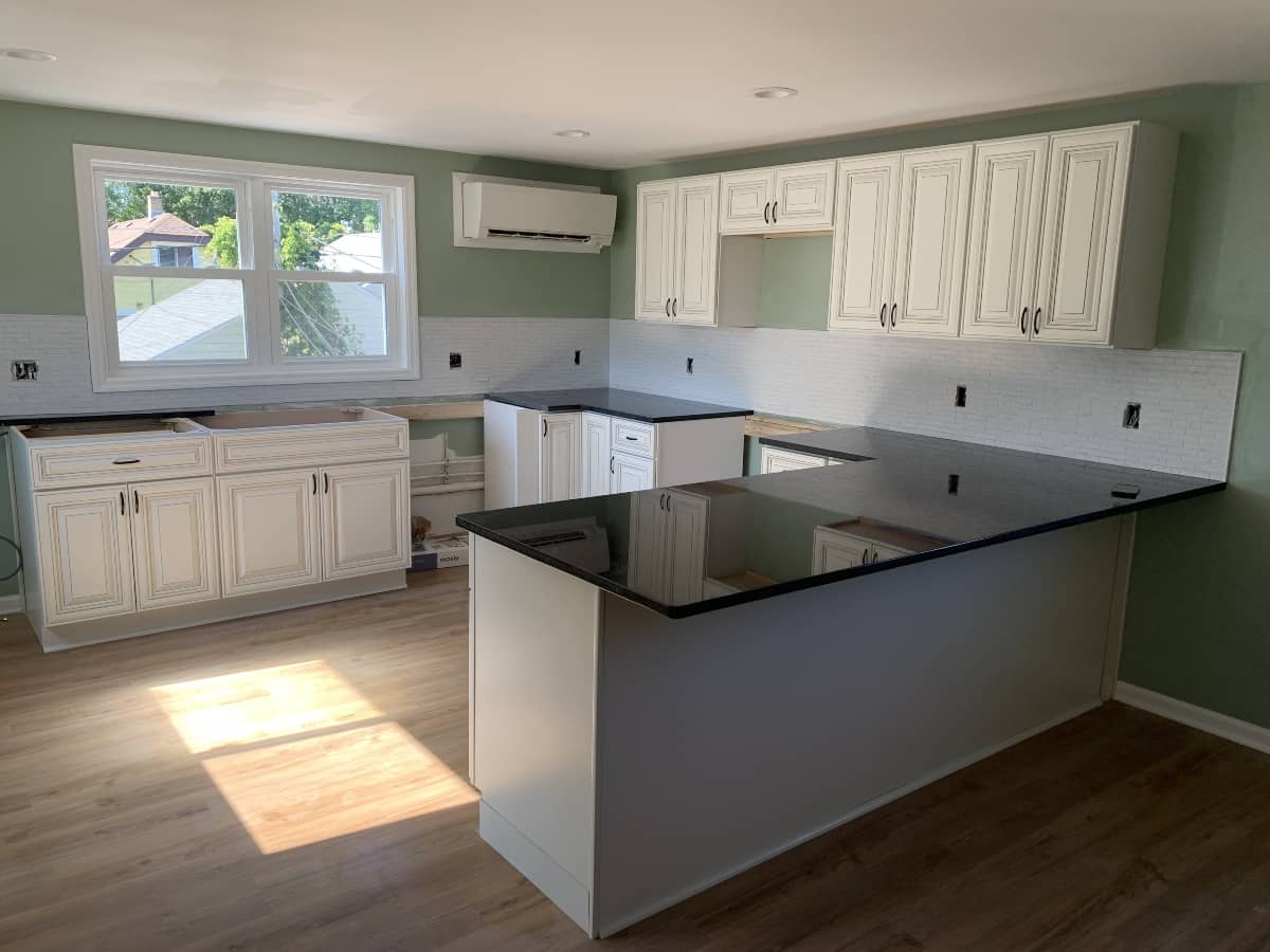 Open-concept kitchen remodel with white cabinets and large island