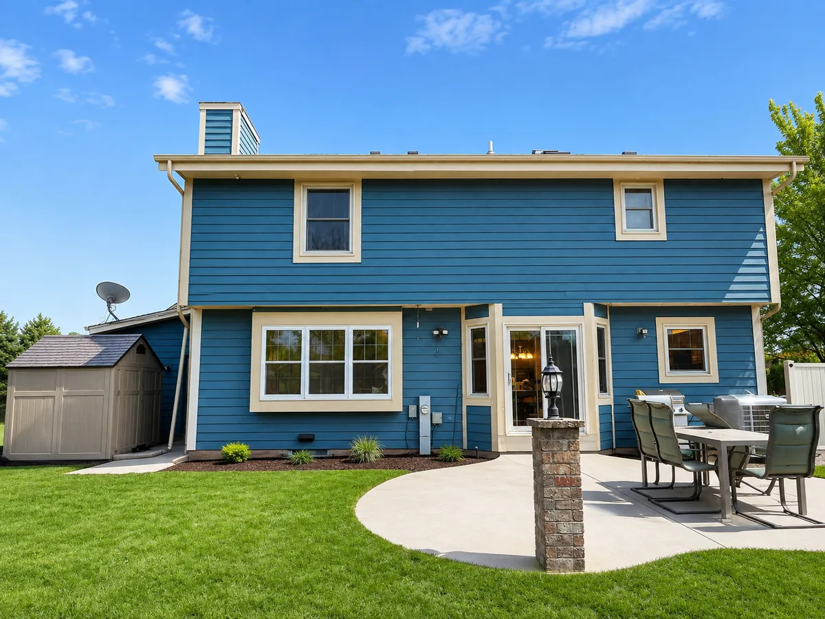 Blue home exterior with a backyard patio