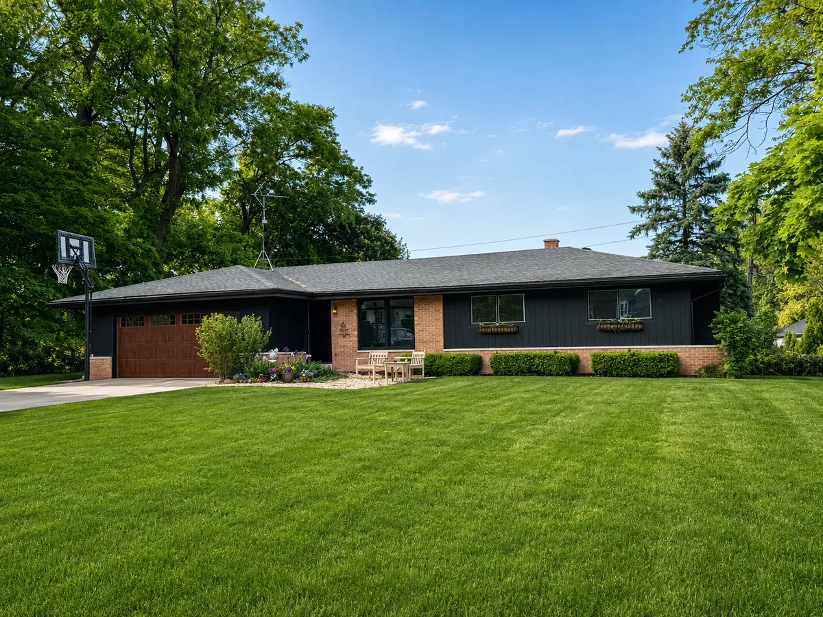 Charcoal ranch home exterior repaint with brick accents