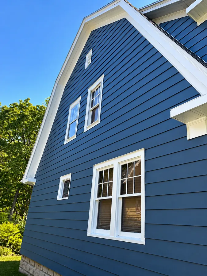 Navy blue siding home with white trim