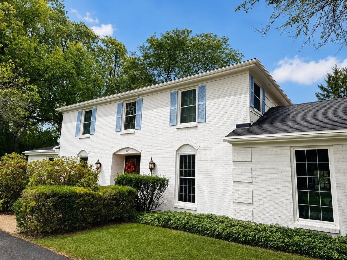 White painted brick colonial home exterior